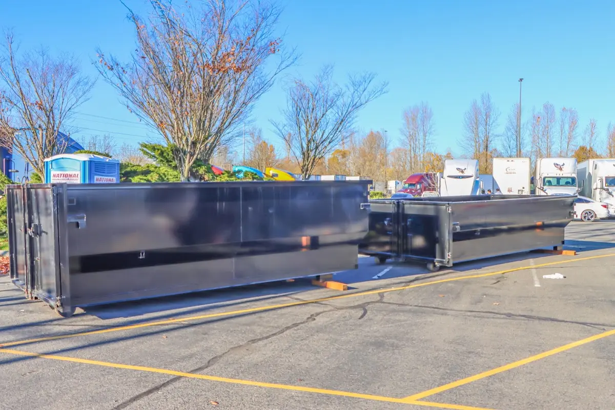 Professional dumpster rental service with roll-off container on residential driveway in Juneau